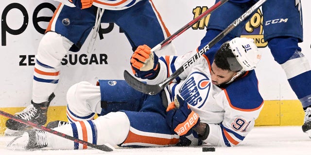 Edmonton Oilers left wing Evander Kane is knocked to the ice during the Lightning game, Tuesday, Nov. 8, 2022, in Tampa, Florida.
