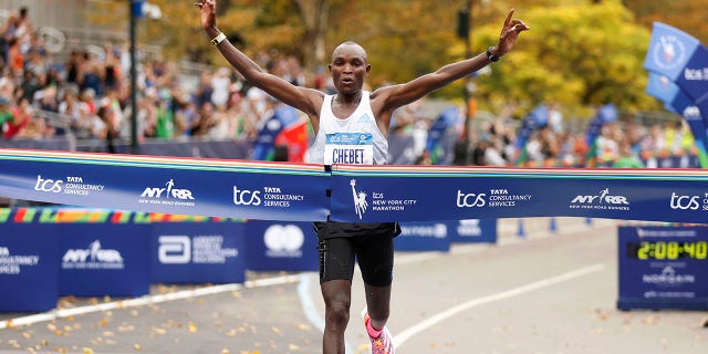 Evans Chebet of Kenya crosses the finish line first in the men's division of the New York City Marathon, Nov. 6, 2022, in New York.