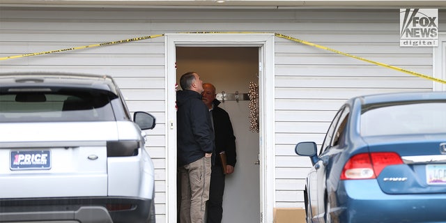 Investigators looked inside the front doorjamb before moving deeper into the house.
