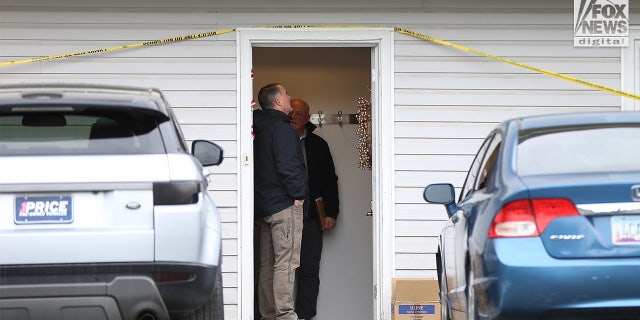 Investigators looked inside the front door jamb before going further into the house.