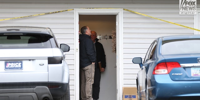 Investigators looked inside the front doorjamb before moving deeper into the house.