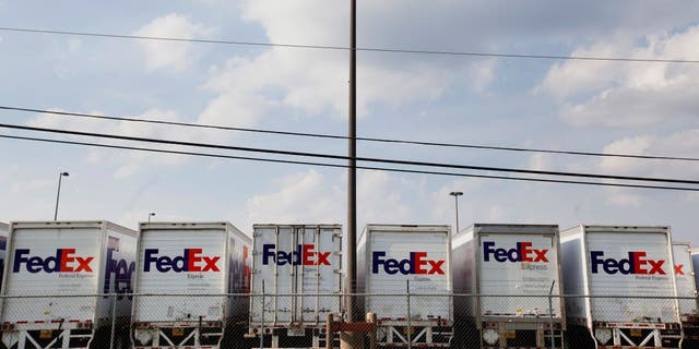 FedEx Corp. trucks sit lined up in a parking lot near the airport in Memphis, Tennessee, on Aug. 16, 2014.