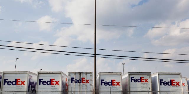 FedEx Corp. trucks sit lined up in a parking lot near the airport in Memphis, Tennessee, on Aug. 16, 2014.