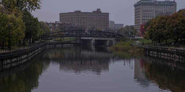 The Flint River flows past downtown Flint, Michigan, on Oct. 22, 2020. Michigan's former health chief is asking courts to stop the effort to revive criminal charges relating to the Flint water crisis.