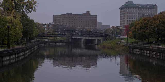 The Flint River flows past downtown Flint, Michigan, on Oct. 22, 2020. Michigan's former health chief is asking courts to stop the effort to revive criminal charges relating to the Flint water crisis.