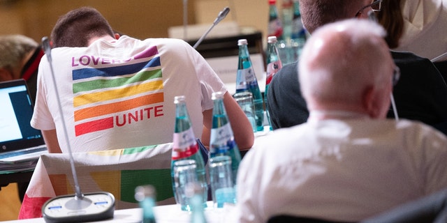 A man wearing a T-shirt with the inscription "Lovers Unite" in rainbow colors of the LGBT community attends the fourth Synodal Assembly of the Catholic Church in Frankfurt, Germany, on Sept. 8, 2022.