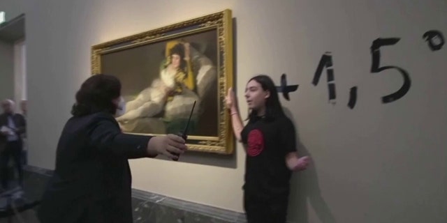 Activists stick to Goya's "Las Majas" to protest against the climate emergency