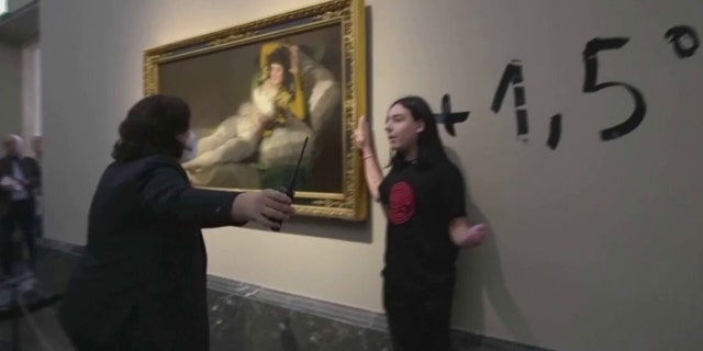 Activists stick to Goya's "Las Majas" to protest against the climate emergency