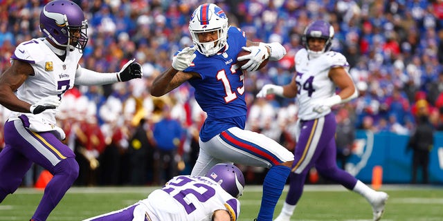 Buffalo Bills wide receiver Gabe Davis, #13, tries to evade Minnesota Vikings cornerback Patrick Peterson and safety Harrison Smith, #22, in the first half of an NFL football game, Sunday, Nov. 13, 2022, in Orchard Park, New York. 