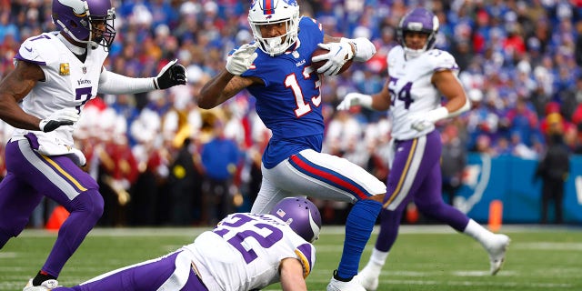 Buffalo Bills wide receiver Gabe Davis, #13, tries to evade Minnesota Vikings cornerback Patrick Peterson and safety Harrison Smith, #22, in the first half of an NFL football game, Sunday, Nov. 13, 2022, in Orchard Park, New York. 