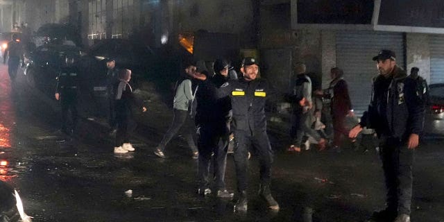 Hamas police officers secure the scene of a burnt apartment on the third floor of a three-story building in Jebaliya refugee camp in the northern Gaza Strip November 17, 2022.