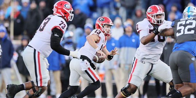 Stetson Bennett (13) of the Georgia Bulldogs runs with the ball against the Kentucky Wildcats at Kroger Field Nov. 19, 2022, in Lexington, Ky.