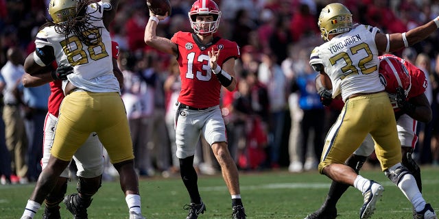 Georgia quarterback Stetson Bennett (13) throws a pass during the first half of an NCAA college football game against Georgia Tech, Saturday, Nov. 26, 2022 in Athens, Ga.