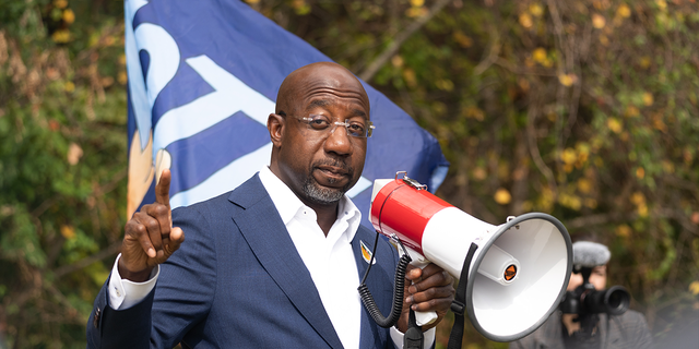Sen. Raphael Warnock meets with community members to encourage them to come out and vote on the first day of early voting on October 17, 2022 in Duluth, Georgia.