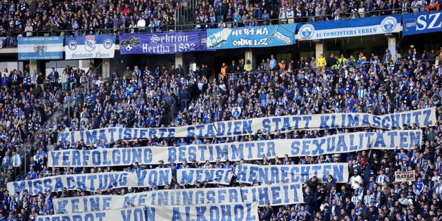 Hertha's supporters hold a protest banner against the World Cup in Qatar during a German Bundesliga soccer match between Hertha BSC Berlin and FC Bayern Munich in Berlin, Germany, Nov. 5, 2022.