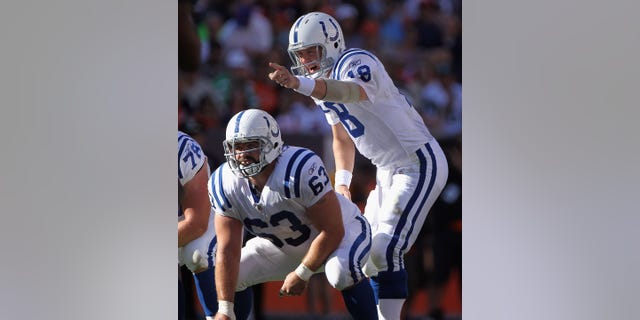 Indianapolis Colts quarterback Peyton Manning, #18, directs the offense as center Jeff Saturday, #63, prepares to snap the ball against the Denver Broncos at INVESCO Field at Mile High on Sept. 26, 2010 in Denver. The Colts defeated the Broncos 27-13.  