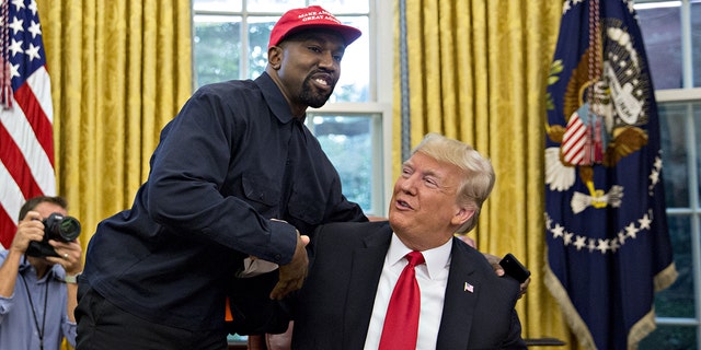 Rapper Kanye West, left, shakes hands with President Trump during a meeting in the Oval Office of the White House in Washington, DC, Oct. 11, 2018. 