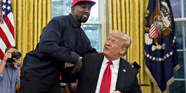 Rapper Kanye West, left, shakes hands with U.S. President Donald Trump during a meeting in the Oval Office of the White House in Washington, D.C., U.S., on Thursday, Oct. 11, 2018. 