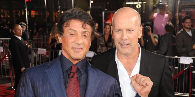 Sylvester Stallone, left, and Bruce Willis pose on the red carpet in 2010.