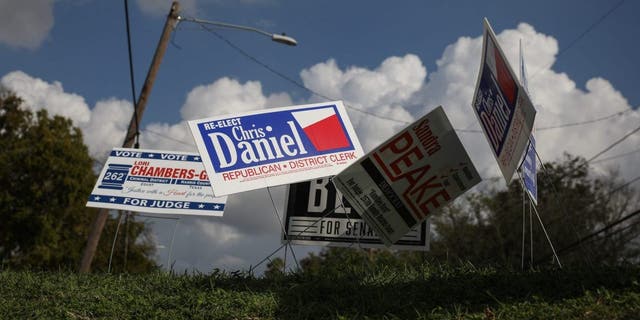 Campaign signs are seen near the Kashmere Multi-Service Center polling place on Nov. 6, 2018, in Houston.