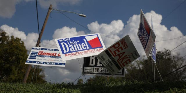 Campaign signs are seen near the Kashmere Multi-Service Center polling place on Nov. 6, 2018, in Houston.