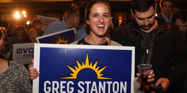 FILE - Democratic supporters listen to Greg Stanton speak after he won Arizona's 9th congressional district during an election night event at the Renaissance Phoenix Downtown on Nov. 6, 2018, in Phoenix.  