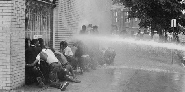 Firefighters use fire hoses to subdue the protesters during the Birmingham campaign in Birmingham, Alabama, May 1963. The movement, which called for the integration of African Americans in schools, was organized by Martin Luther King Jr. and Fred Shuttlesworth, among others.
