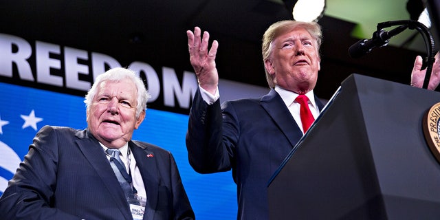 President Donald Trump, right, speaks next to Bill Bennett during the Faith and Freedom Coalition's Road to Majority conference in Washington, D.C., on June 26, 2019.