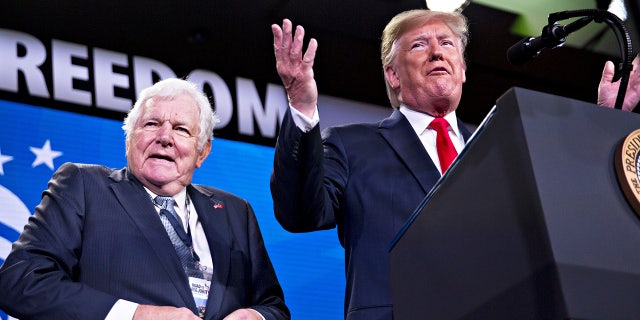 President Donald Trump, right, speaks next to Bill Bennett during the Faith and Freedom Coalition's Road to Majority conference in Washington, D.C., on June 26, 2019.