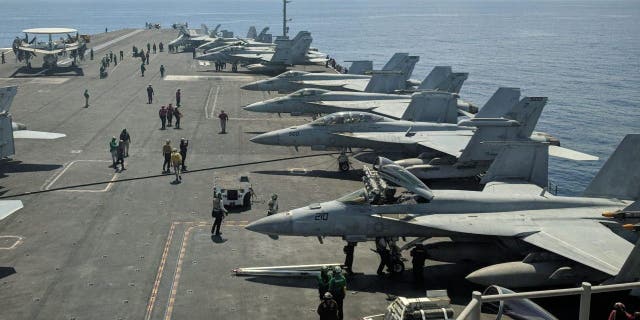 This photograph taken Oct. 16, 2019, shows U.S. Navy F/A-18 Super Hornets multirole fighters and an EA-18G Growler electronic warfare aircraft, second right, on board the USS Ronald Reagan (CVN-76) aircraft carrier as it sails in the South China Sea on its way to Singapore. 