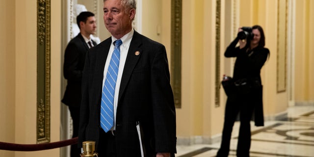 Rep. Fred Upton (R-MI) pays his respects over the flag-draped casket of US Rep. Elijah Cummings (D-MD) as Cummings lies in state outside of the House Chamber in the Will-Rodgers corridor of the US Capitol October 24, 2019, in Washington, D.C.