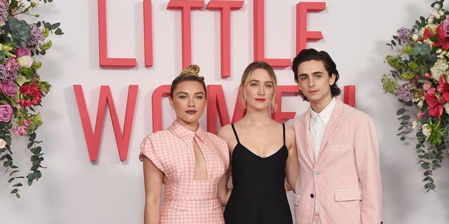 From left to right, Florence Pugh, Saoirse Ronan and Timothee Chalamet pose at the evening photo call for "Little Women" at The Soho Hotel London on Dec. 16, 2019, in London, England. 