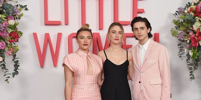 From left to right, Florence Pugh, Saoirse Ronan and Timothee Chalamet pose at the evening photo call for "Little Women" at The Soho Hotel London on Dec. 16, 2019, in London, England.