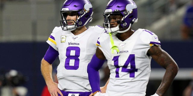 Kirk Cousins (8) and Stefon Diggs (14) of the Minnesota Vikings stand on the field during a game against the Dallas Cowboys at AT and T Stadium Nov. 10, 2019, in Arlington, Texas. 