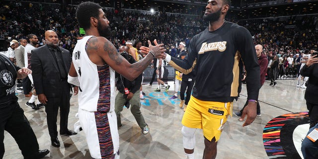 Kyrie Irving, #11 of the Brooklyn Nets, and LeBron James, #23 of the Los Angeles Lakers, hi-five after a game on Jan. 23, 2020 at Barclays Center in Brooklyn, New York.