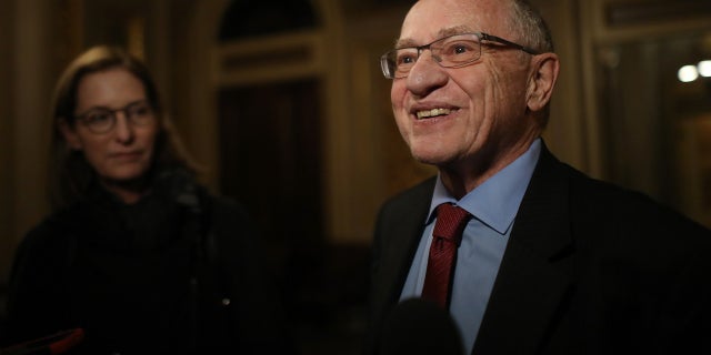 alan dershowitz smiling in media scrum