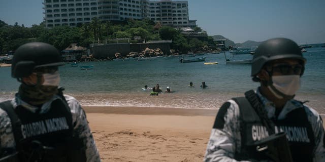 Members of the National Guard stand guard at a beach in Acapulco, Guerrero state, Mexico.