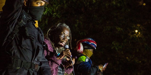 Hardesty with protesters in riot gear