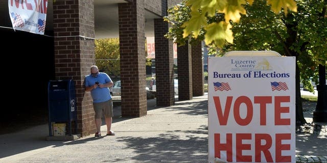 A man waits outside the Luzerne County Board of Elections where people drop off and request for mail-in ballots. 