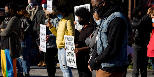 Community members take a moment of silence while rallying together at the location of the former Wendy's where Rayshard Brooks was shot and killed on January 18, 2021, in Atlanta, Georgia. 