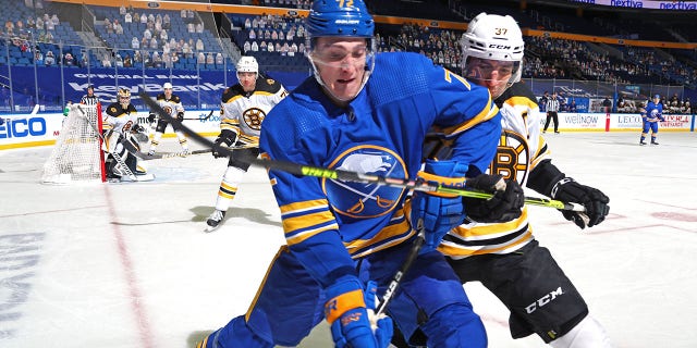 Tage Thompson of the Buffalo Sabres, foreground, battles against Patrice Bergeron of the Boston Bruins during a game April 22, 2021, at KeyBank Center in Buffalo.