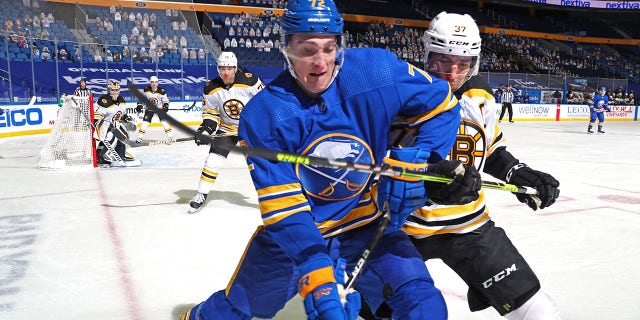 Tage Thompson of the Buffalo Sabres, foreground, battles against Patrice Bergeron of the Boston Bruins during a game April 22, 2021, at KeyBank Center in Buffalo. 