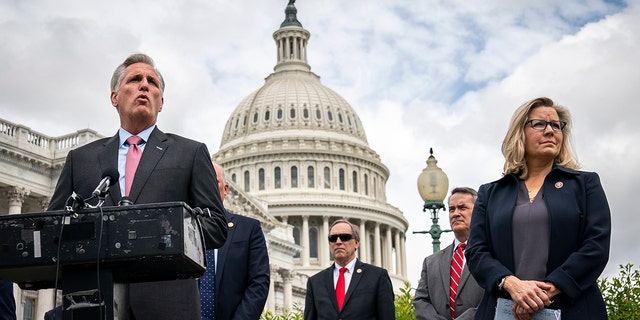 At right, Rep. Liz Cheney, R-Wyo., stands with House Minority Leader Rep. Kevin McCarthy (R-Calif.) as he speaks during a news conference outside the U.S. Capitol in Washington, DC. 