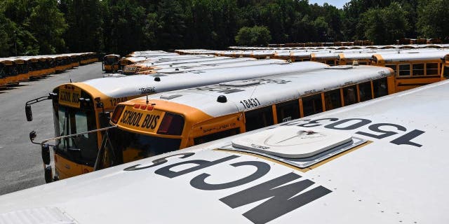 School buses sit idle at the Montgomery County Public Schools maintenance and operations depot on Aug. 12, 2021, in Bethesda, Maryland.