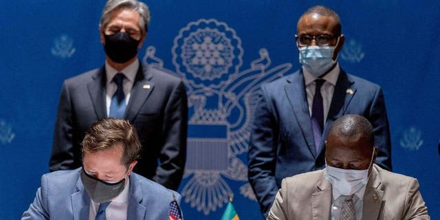 ABD Group CEO John Nevergole, pictured on the bottom left, participates in a MOU signing in Senegal, which featured remarks from Secretary of State Antony Blinken, pictured behind Nevergole.