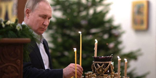 Russian President Vladimir Putin attends an Orthodox Christmas Mass in a church at the Novo-Ogaryovo state residence near Moscow Jan. 7, 2022.