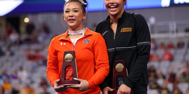 Sunisa Lee of the Auburn Tigers and Mya Hooten of the Minnesota Golden Gophers tie for fourth place on floor exercise during the Division I Women's Gymnastics Championships at Dickies Arena on April 14, 2022, in Fort Worth, Texas.