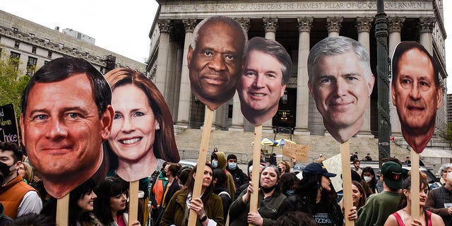 Protesters hold signs of U.S. Supreme Court justices during a pro-abortion protest in New York City on Tuesday, May 3, 2022. 