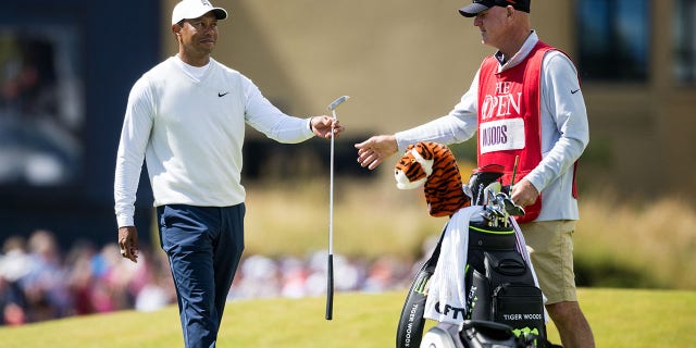 Tiger Woods and caddie Joe LaCava on the 18th tee during Day Two of The 150th Open at St Andrews Old Course on July 15, 2022 in St Andrews, Scotland.