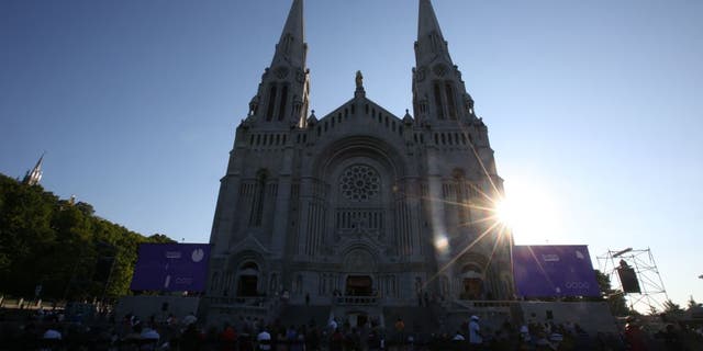 Catholic faithful await Pope Francis at the National Shrine of Sainte-Anne-de-Beaupré in Quebec, Canada.